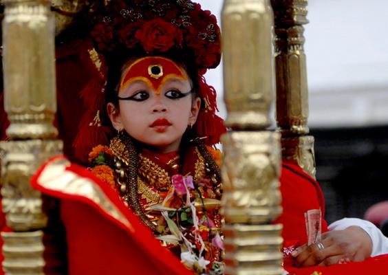 Nepalese living goddess Kumari Mateena Shakya sits on a chariot as she is taken towards Teleju temple on the occassion of the Chaite Dashain festival in Kathmandu.